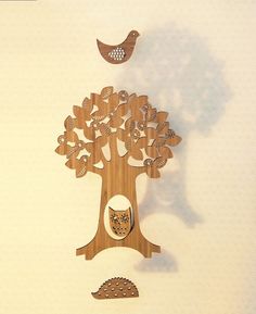 a wooden cutout of a tree with a bird perched on it's head