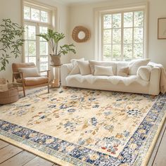 a living room filled with furniture and a large rug