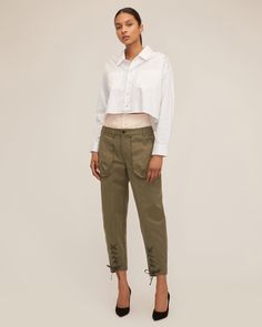 Honoring our brand's heritage, we updated the classic utilitarian cargo pant with feminine details. A high waist corset waistband is paired with vintage washed cargo details to give the Ada its modern feel. Pair the Ada with a classic white shirt or a tank for a ready to go everyday anywhere look. High corset waist Front fly zipper and Horn button closure Shell button closure on attached corset Front cargo pockets, back patch pockets with flap Belt loops Tapered Leg Front lace up detail at the h Spring Military Style Cotton Cargo Jeans, Military Style Cargo Jeans For Spring, Chic Fall Cargo Parachute Pants, Chic Fall Cargo Style Parachute Pants, Chic Cargo Style Parachute Pants, Spring Military Cargo Parachute Pants, Spring Parachute Pants With Flap Pockets, High Rise Pants With Flap Pockets For Spring, Spring High Rise Pants With Flap Pockets