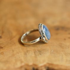 We are very excited about the look and feel of our new Deep Blue Kyanite Lasso Ring! This Boho Blue Kyanite Ring looks and feels great - you won't want to take it off! Perfectly balanced with a healthy sized 10X14mm Blue Kyanite stone, .925 Sterling silver accents and half-round shank - super comfortable and easy to wear. This ring's all sterling silver details are unique and truly set off the stone! You might want to make room on your hand -- you're going to want to wear this Blue Kyanite State Blue Topaz Natural Stone Ring, Blue Topaz Ring With Natural Stones, Spiritual Blue Moonstone Ring, Blue Wedding Rings With Natural Stones, Wedding Blue Rings With Natural Stones, Adjustable Blue Rings With Large Stone, Blue Rings With Large Stone For Healing, Handmade Adjustable Sapphire Ring, Adjustable Blue Moonstone Promise Ring