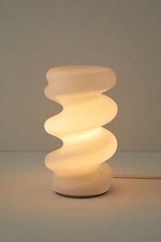 a white lamp sitting on top of a table