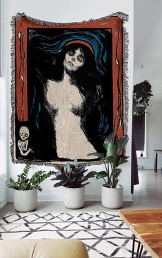 a painting hanging on the wall in a living room with potted plants next to it