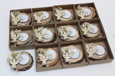 twelve decorated coconuts in boxes on a table