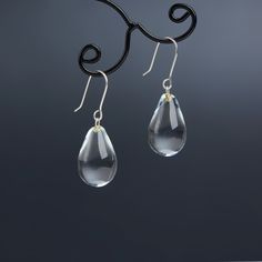 "These Small clear teardrop earrings are made of glass in lampwork technique. The earrings hooks are sterling silver and are hypoallergenic. These unique and beautiful earrings are like water drops frozen in glass! They are simple and elegant, very lightweight and comfortable to wear, perfect for everyday wear and for special occasions. 💕 You will definitely receive lots of compliments on your new earrings, everybody loves them, and you'll love them too! Dimensions: total length about 1 1/8\" i Minimalist Teardrop Glass Jewelry, Glass Drop Earrings With Matching Set, Modern Glass Teardrop Earrings, Nickel-free Glass Drop Jewelry, Glass Drop Earrings As Gift, Hypoallergenic Glass Teardrop Jewelry, Glass Teardrop Earrings With Ear Wire, Teardrop Glass Earrings With Ear Wire, Silver Teardrop Crystal Earrings For Everyday