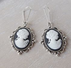 This lovely yet rose cameo earrings are just divine. This lovely piece of jewelry measures to fit a 25x18 mm cameo and comes with great antique toned french hook style dangle earrings. These gorgeous earrings measure 1 3/4 inches in length and would be the perfect gift for you or someone special. Bracelet cameo: https://www.etsy.com/listing/619538477/cameo-bracelet-silver-colored-victorian?ref=shop_home_active_1&pro=1&frs=1 All items come wrapped individually in a ribboned gift box. Please visit Silver Cameo Earrings As A Gift, Cameo Drop Earrings For Gifts, Victorian Cameo Earrings For Gift, Earrings Goth, Black Cameo, Cameo Bracelet, Goth Earrings, Cameo Earrings, Vintage Goth