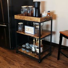 a shelf with coffee mugs on it in front of a refrigerator and wooden table