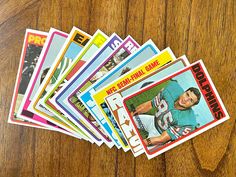 a bunch of baseball cards sitting on top of a wooden table