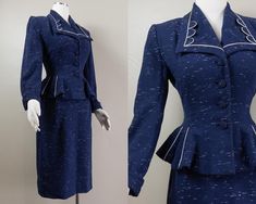 This is a stunningly sharp 50s blue wool suit set by Lilli Ann. It is a chic suit jacket with a wide lapel collar and geometric piping details. It has lightly padded shoulders, long cuffed sleeves, and a frilly peplum hem. It buttons down the center front with matching fabric covered buttons and with the peplum it makes the waist look cinched. There are also more white piping details in the peplum. The jacket is lined in a navy blue silk crepe with the Lilli Ann tag at the back of the neck and the QDA and union label at the side seam. The skirt is a simple but chic pencil style in matching blue wool and falls past the knees with a kick pleat in the back. The skirt fastens with a button on the waistband and a hidden metal zip. The skirt has the same silk crepe lining panel from the waist to Vintage Fitted Skirt Suit With Notch Lapel, Vintage Blue Skirt Suit For Formal Occasions, Vintage Fitted Blue Suits, Blue Fitted Vintage Suit, Fitted Vintage Blue Suits, Retro Fitted Skirt Suit For Tailoring, Retro Fitted Spring Suits, Retro Fitted Suits For Spring, Vintage Fitted Suits For Office