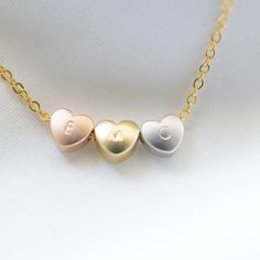 "Tri-Colour Heart Necklace the heart can be blank or personalised and comes on a rose gold, gold or rhodium plated chain. Excellent Gift Idea for 3 Best Friends/Sisters or even your bridesmaids or a 30th Birthday Gift This listing is for 1 necklace with 3 heart beads, please note that the hearts are not fixed in the middle and will slide around the chain. ✏️DESCRIPTION * High quality Gold Silver or Rose Gold Plated cable chain * Rose Gold, Silver and Gold Plated Hearts Charms * Spring clasp and Customizable Rose Gold Heart Necklace For Valentine's Day, Personalized Rose Gold Heart Necklace For Valentine's Day, Rose Gold Heart-shaped Name Necklace For Valentine's Day, Valentine's Day Rose Gold Heart Name Necklace, Heart Charm Name Necklace For Birthday Gift, Dainty Heart Necklace, Tiny Heart Necklace, Best Friend Necklace, Best Friends Sister