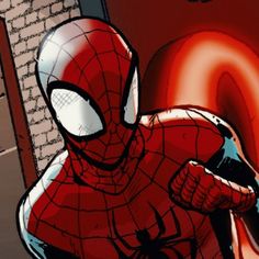 a spider - man is standing in front of a brick wall