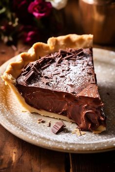 a piece of chocolate pie sitting on top of a white plate