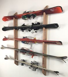 a rack with skis and snowboards mounted to it's sides on a wall