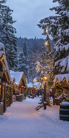 A charming Christmas village scene with snow-covered cottages adorned with twinkling lights, creating a magical winter wallpaper perfect for holiday phone backgrounds. Christmas Lights Village, Winter Wonderland Wallpaper, Village Market, Cozy Cabins