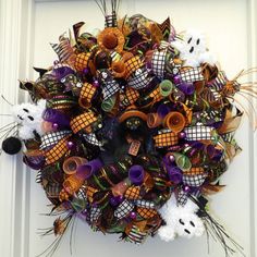 a halloween wreath is hanging on the front door