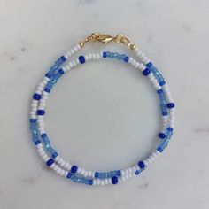 🌸 A pretty necklace in blue and white seed beads. 🌼 SIZE Necklace is 43,5cm long. If you want shorter (choker style 38-39cm), then please let me know. If you want it longer I will add an extention chain. 🌻 MATERIAL The lock is gold plated, and with time the gold plating will wear off. Please do not wear the necklace while sleeping, showering or doing sports. Water and chemicals like perfume and lotions will make the gold plating tarnish. Necklace is handmade by me. 🎁 It comes in a silk organ Formal Beaded Necklace, Seed Bead Bracelets Ideas, Beaded Jewelry Necklaces, Pretty Necklace, Bracelets Design, Beads Bracelet Design, Sports Water, Choker Style, Pretty Necklaces