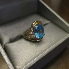 Vintage 14KT Yellow Gold Ring is gorgeous. Three Plus CT Large Oval Blue Topaz Ring with Three Nice Size Genuine Diamonds on One Side of Band. The Gold Band has a Double Swirl on One Side and this Ring is a Size 5. Ring is Hallmarked inside of Band 14K with Maker's Mark. Three Oval Diamonds and they are a nice size. In excellent vintage condition. FREE SHIPPING. FREE SHIPPING - GIFT WRAPPED PERFECT - 10% OFF AT CHECKOUT. I HAVE NOT SEEN A MORE BEAUTIFUL RING AT A VERY VERY VERY GREAT PRICE. Turquoise Blue Topaz Rings Fine Jewelry, Turquoise Topaz Ring With Gemstone Accents, Heirloom Oval Topaz Ring With Diamond Accents, Fine Jewelry Topaz Birthstone Ring With Accent Stones, Blue Topaz Diamond Ring With Gemstone Accents, Sapphire Rings With Topaz And Gemstone Accents, Blue Topaz Gemstones With Accent Stones For Promise Ring, Turquoise Blue Topaz Ring With Gemstone Accents, Diamond-accented Topaz Ring As A Gift