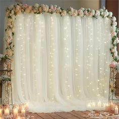 a wedding backdrop with flowers and candles