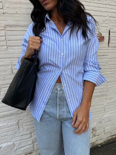 a classic button up staple with an open back concept for a super on trend look! this blue striped button up shirt bring coastal coastal corporate. pair with a fun bubble skirt, baggy jeans or trousers for a unique style! shop more trending tops here! size, details & care model size Dee is 5'5" 135lbs with a 34" chest, 27" waist, and 38" hip wearing a small details 60% polyester, 40% cotton care dry clean only do not bleach do not tumble dry Arizona Outfits, Trending Tops, Dressy Pants, Bubble Skirt, Small Details, Dressy Tops, Denim Pant, Baggy Jeans, Dress Romper