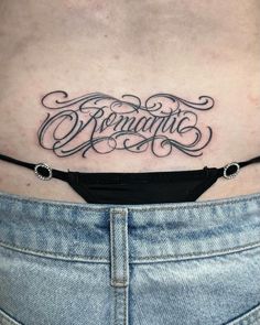 a woman's stomach with an inscription tattoo on it