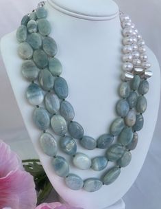 Aquamarine Pearl Necklace, hand knotted in green silk thread, flat 12 to 20 mm flat aquamarine stones, 8 mm fresh water pearls, 6 mm rock crystal, 12 mm unique sterling silver beads with sterling silver findings and extender clasp. t This graduated triple strand, one of a kind necklace is 18 inches in length plus 2.5 inch sterling silver extender clasp' handcrafted in the Palm Beaches by designer artist Christine Smith. Elegant Hand-strung Aquamarine Jewelry, Elegant Single Strand Amazonite Beaded Necklace, Elegant Amazonite Gemstone Beaded Necklace, Fresh Water Pearls, Aquamarine Stone, Jade Carving, Water Pearls, Asymmetrical Design, Jade Beads