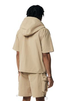 Relaxed Fit Tops With Cargo Pockets For Outdoor, Collared Outdoor Tops With Side Pockets, Collared Tops With Side Pockets For Outdoor, Urban Hooded Tops For Outdoor, Urban Hooded Top For Outdoor, Khaki Outerwear For Outdoor Activities In Spring, Khaki Collared Utility Jacket For Streetwear, Khaki Techwear Tops For Outdoor, Casual Beige Utility Jacket With Cargo Pockets