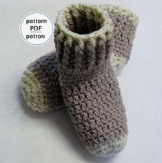 a pair of crocheted baby booties sitting on top of a white table