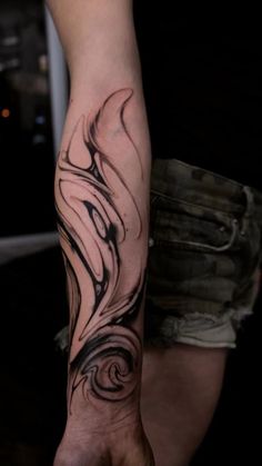 a person with a black and white tattoo on their arm