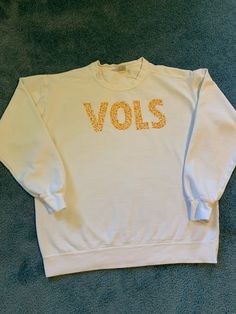 Tennessee Volunteers Floral Embroidered SweatShirt/T-Shirt. White Embroidered T-shirt For Fall, White T-shirt With Embroidered Text For Fall, Oversized Embroidered White Top, Casual Embroidered Tops For College, Oversized White Embroidered Top, White T-shirt With Embroidered Graphics For Fall, Oversized White Sweatshirt With Letter Embroidery, Casual Short Sleeve Sweatshirt With Embroidered Text, White Embroidered Graphic T-shirt For Fall