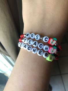 *This adorable teacher's bracelet will make a perfect gift.* *You choose what you would like the bracelet to say. Some examples are: Teacher, Teach, Inspire, Teachers name or initial.* *Mode is shown wearing a size 6.75 inch.* *Please measure wrist before ordering.* **Please roll on bracelet rather than stretch on to prevent breaking.** Student Teacher Bracelets, Personalized Adjustable Bracelets For Teacher Appreciation, Customizable Adjustable Jewelry For School, Personalized Adjustable Bracelet For Teacher Appreciation, Adjustable Letter Beads Jewelry For Teacher Appreciation, Personalized Multicolor Bracelets For Teacher Appreciation, Customizable White Bracelets For Teacher Appreciation, Trendy Personalized Jewelry For School, Personalized White Name Bracelet For Teacher Appreciation