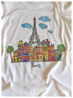 a white shirt with the eiffel tower painted on it