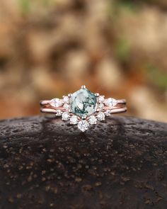 a close up view of a ring with an aqua and white stone in the center