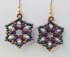 a pair of earrings with pearls and beads