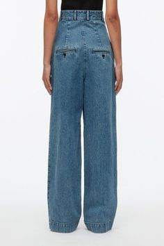 This fashion forward style is cut with stone and enzyme washed denim. With an exaggerated high waist, it elongates the silhouette and accentuates the waist. Wear with a cropped top. 100% Cotton Tailored full length Professional dry clean only Model is 5'10', Bust: 30', Waist: 23', Hips: 34' and wearing a size 4 Cropped Denim Blue Pants With Five Pockets, Dark Wash Cropped Pants With Five Pockets, Dark Wash Cropped Denim Pants, Fitted Wide Leg Recycled Denim Pants, Fitted Wide-leg Recycled Denim Pants, Modern Light Wash High-waist Bottoms, Modern Light Wash High Waist Bottoms, Modern High Waist Light Wash Bottoms, Modern High-waist Light Wash Bottoms