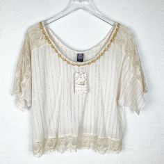 Short Sleeve Blouse In Ivory By Free People. Lace Detailing On Sleeves, Shoulders And Bottom Hem. Beaded Neckline. Oversized Fit. Metallic Golden Accents. Cottagecore Style. Pit To Pit: ~25" Length: 22" Condition: Nwt Any And All Flaws (If Existing) Are Noted In Listing. Bundle Up For A Discount! 500+ Items Available In My Closet. Q109 Chic Embellished Beige Tops, Chic Beige Embellished Tops, Off White Bohemian Short Sleeve Top, Bohemian Off White Short Sleeve Tops, Elegant Cream Embellished Tops, Summer Embellished Beige Blouse, Beige Embellished Blouse, Embellished White Blouse For Summer, Off White Bohemian Lace Tops