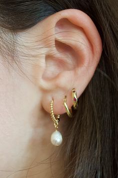 Elevate your earring game with our Pearl Huggie Earrings. These multiple styles include a simple, textured huggie and a CZ huggie, all adorned with lustrous freshwater pearls. The perfect combination of elegance and versatility. Earring Stack Ideas, 2024 Accessories, Earring Stack, Swim Gifts, Stationary Gifts, Gold Jewelry Necklace, Anklet Bracelet, Huggie Earrings, Socks And Sandals