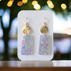 Confetti Glitter Earrings, Available in two captivating styles, these earrings feature a stunning trapezoid design adorned with an enchanting array of confetti glitter, meticulously arranged to catch and reflect light in a dazzling display of sparkles. Measuring 2.50 inches from the hook and 0.75 inches in width. With hypoallergenic findings, they ensure comfort and confidence for wearers with sensitive ears. Atop the trapezoid silhouette sits a sleek brass disc, adding a touch of refinement to the ensemble. creating a harmonious balance between sophistication and playfulness. Earrings come in a gift bag with a polishing cloth:) safely packaged in a shipping box.  Please contact me with any questions. Trendy Dangle Jewelry For Birthday, Trendy Gold Earrings As A Gift For Her, Glitter Party Jewelry, Trendy Festive Drop Earrings, Trendy Drop Earrings As Gift For Her, Trendy Drop Earrings - Gift For Her, Trendy Gold Glitter Earrings, Trendy Glitter Gold Earrings, Elegant Glitter Jewelry For Parties