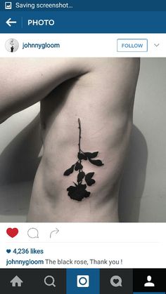 a black rose tattoo on the side of a woman's stomach is shown in this photo