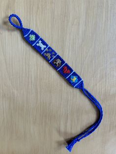 a blue lanyard with an old school video game design on it's side