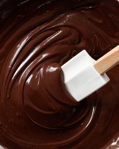 a wooden spatula filled with melted chocolate