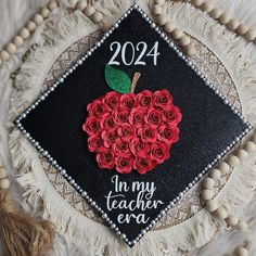 a decorated graduation cap with roses on it