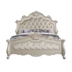 a white bed with an ornate headboard and foot board is shown against a white background