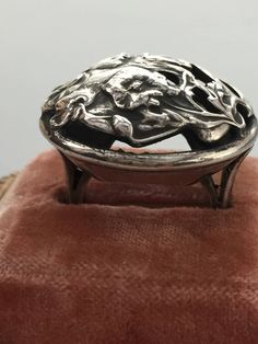 Gorgeous authentic ART NOUVEAU dome ring fashioned after the works of Alphonse Mucha. The ring features a beautiful woman with flowing hair surrounded by flowers and sinuous vines. The ring is heavy weighing 14.175 grams of silver. It is marked STERLING on the outside of the band. I did polish it a little because it was completely tarnished when I bought it but still retains much of the original patina. A great piece to wear or add to any vintage or antique jewelry collection. It is a woman's Si Art Nouveau White Gold Jewelry, Art Nouveau White Gold Round Jewelry, Artistic Hallmarked Jewelry For Formal Occasions, Antique Handmade Silver Rings, Art Nouveau Engraved Rings Collectible, Antique Handmade Rings In Antique Silver, Art Nouveau Engraved Round Rings, Art Nouveau Engraved Collectible Rings, Art Nouveau White Gold Rings For Formal Occasions