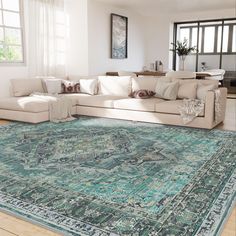 a living room with a large rug on the floor next to a couch and windows