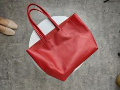 Overview: Design: Fashion Womens Red Leather Oversize Tote Bag Red Shoulder Tote Bag Handbag Tote For WomenIn Stock: Made to order (2-3 days)Include: Tote + A detachable Side InnerCustom: NoColor: RedLeather: CowhideMeasures: Horizontal Style S: 46cm/Bottom 34cm x 30cm x 14cmHorizontal Style L: 50cm/Bottom 37cm x 33cm x 16cm Vertical Style S: 41cm/Bottom 33cm x 35cm x 11cm Vertical Style L: 47cm/Bottom 37cm x 40cm x 11cmWeight: 0.75 kgSlots: 1 slotAccessories(option): NoStyle: Tote Bag, Shoulder Elegant Large Square Shoulder Bag, Large Top Handle Bag For Everyday Use, Chic Large Shoulder Bag For Shopping, Large Tote Bag For Office, Elegant Large Size Satchel For Shopping, Large Office Tote Bag, Large Chic Satchel For Shopping, Chic Large Size Top Handle Shoulder Bag, Large Rectangular Leather Bag