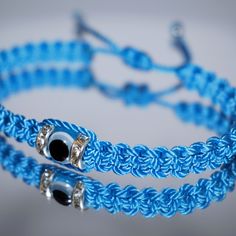 Durable Hand-Made Light Blue String Bracelet With An Evil Eye For Wrist Sizes 6 To 9 In, With An Easy To Use Zip Like Function To Fit Your Wrist, Made From High Quality Light Blue String, It Will Be Sure To Last. Wearing An Evil Eye As An Amulet Is Believed To Provide Protection Against Evil Forces. The Evil Eye Meaning Has Symbolism In Almost Every Country In The World And In Every Religion. Each Bracelet Is Carefully Handcrafted And Give Proper Time To Ensure Quality. Blue Resizable Bangle Jewelry, Blue Adjustable Bracelet Jewelry, Adjustable Blue Friendship Bracelets With Evil Eye, Blue Adjustable Bangle Bracelet, Blue Adjustable Jewelry As A Gift, Blue Adjustable Braided Bracelets As Gift, Blue Adjustable Braided Bracelet For Gift, Blue Jewelry With Adjustable Length For Gift, Blue Braided Bracelet With Adjustable Length As Gift