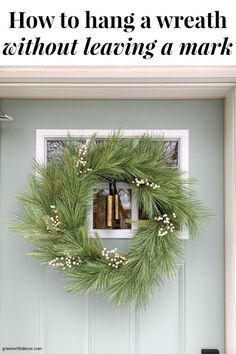 a wreath hanging on the front door of a house that says how to hang a wreath without leaving a mark