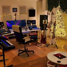 a room filled with lots of musical instruments and christmas tree in the corner, surrounded by holiday decorations