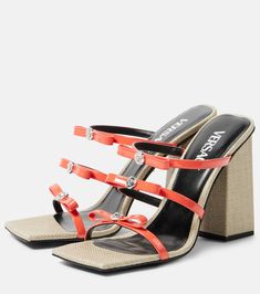 a pair of high heeled sandals with straps