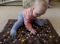 a baby is playing with buttons on the floor