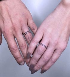 two people with wedding rings on their fingers, one holding the other's hand